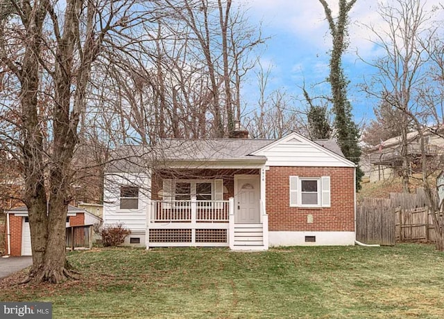 bungalow with covered porch and a front lawn