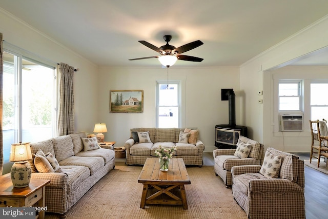 living area with ornamental molding, plenty of natural light, and cooling unit