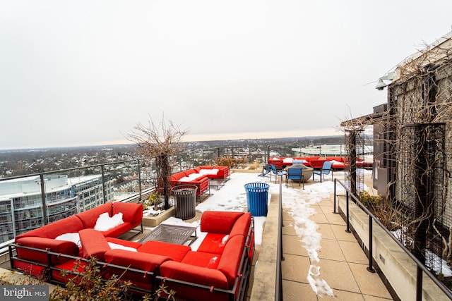 snow covered patio with an outdoor living space