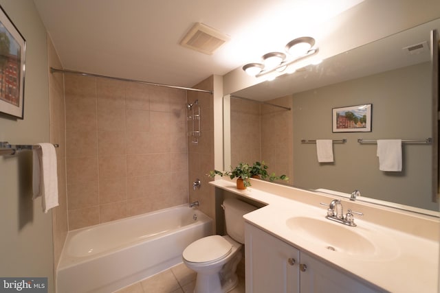 full bathroom featuring tiled shower / bath, tile patterned floors, vanity, and toilet