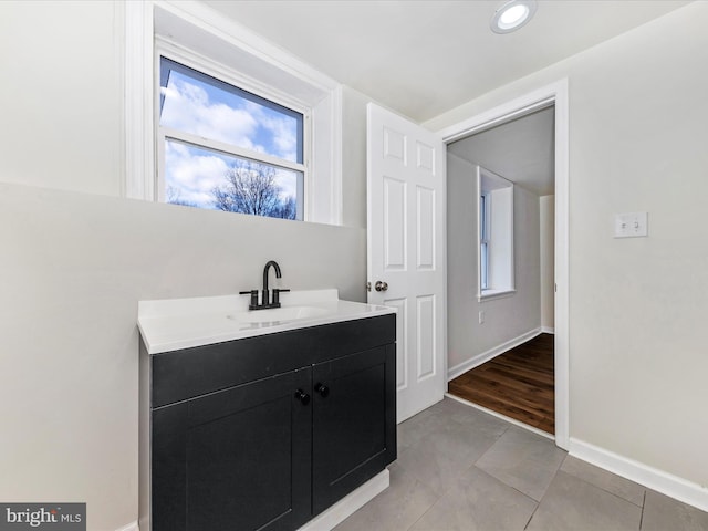 bathroom featuring tile patterned flooring and vanity