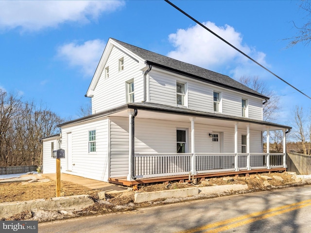 farmhouse inspired home featuring covered porch