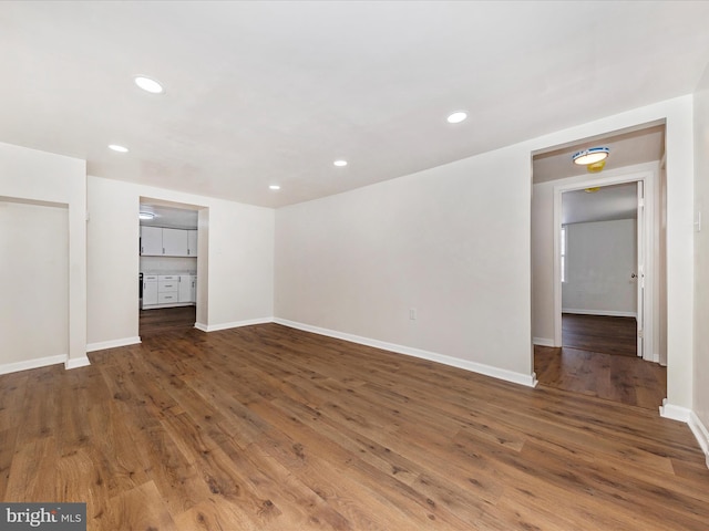 unfurnished room featuring dark wood-type flooring