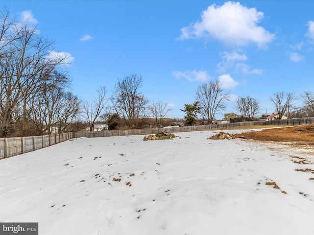 view of yard layered in snow