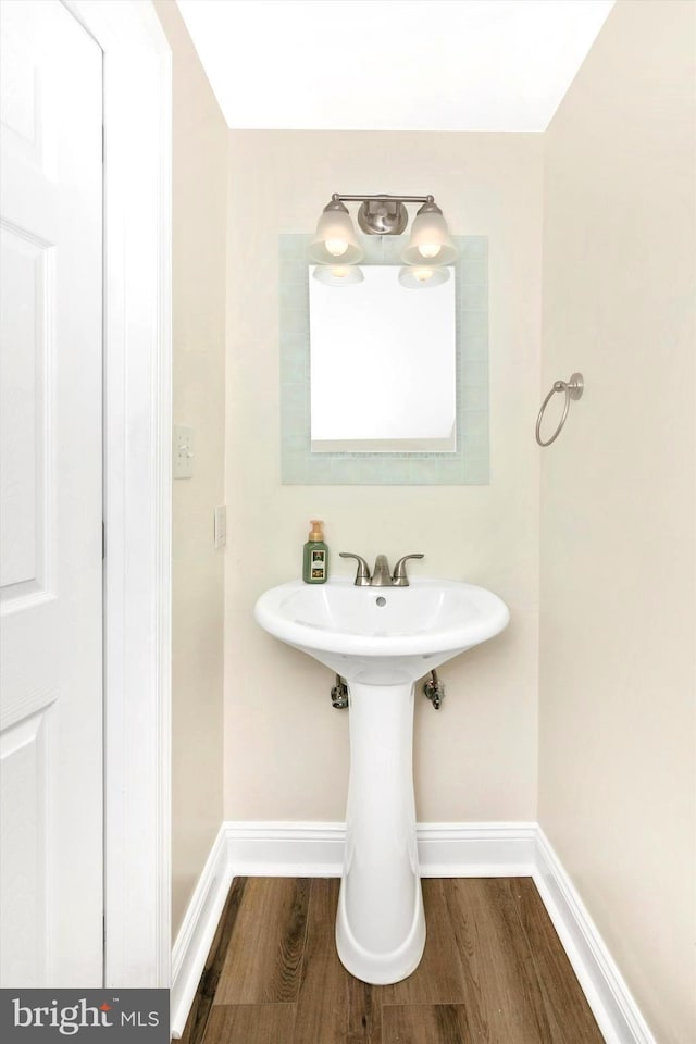 bathroom featuring baseboards and wood finished floors