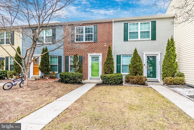 view of front of house with brick siding and a front yard