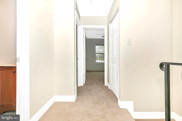 hall with light carpet and baseboards