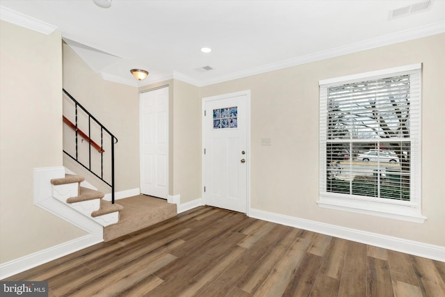 entrance foyer with stairway, wood finished floors, visible vents, and baseboards