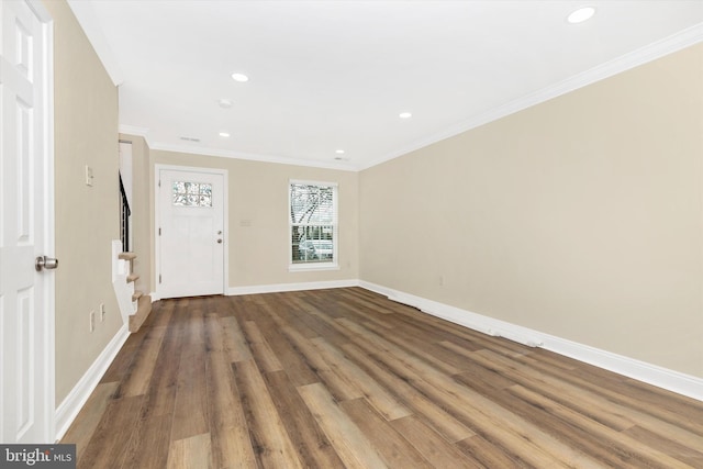 interior space with baseboards, ornamental molding, wood finished floors, and recessed lighting