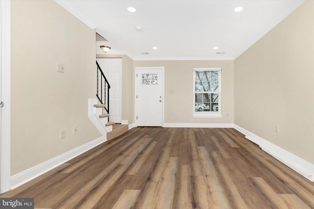 entrance foyer with baseboards, stairway, and crown molding