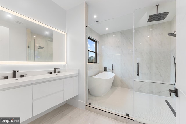 bathroom with vanity and separate shower and tub