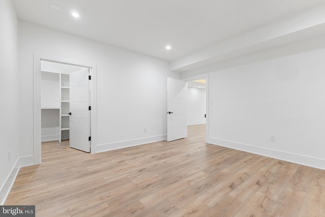 unfurnished room with light wood-type flooring