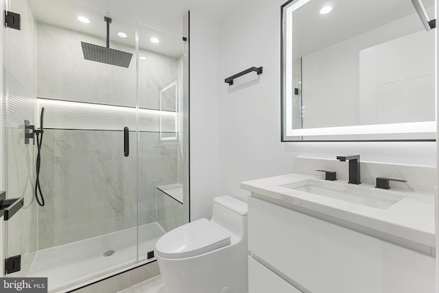 bathroom with vanity, toilet, and an enclosed shower