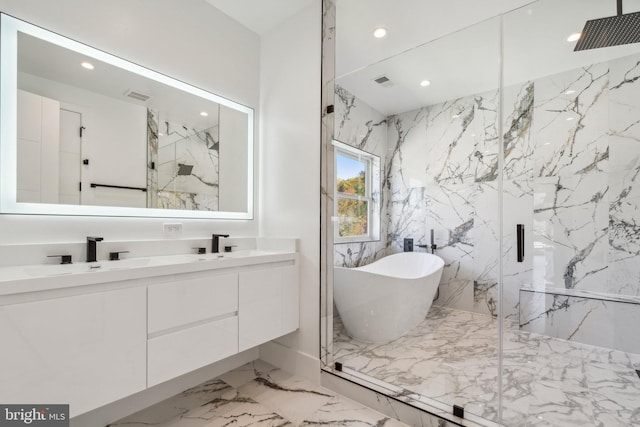 bathroom with vanity and separate shower and tub