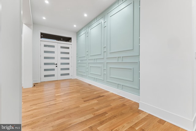 corridor with light hardwood / wood-style floors