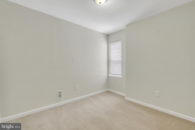 unfurnished room with light carpet