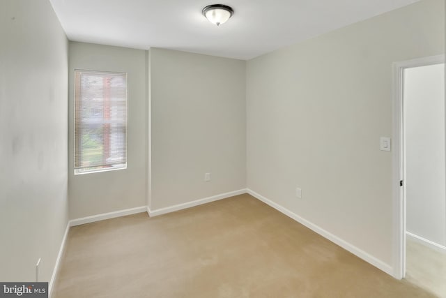 spare room with light colored carpet