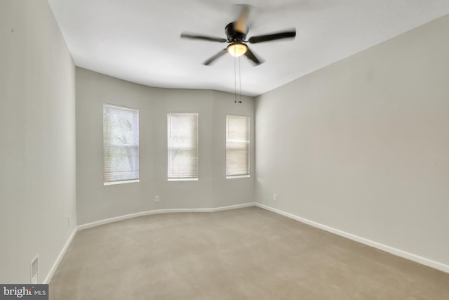 carpeted spare room with ceiling fan