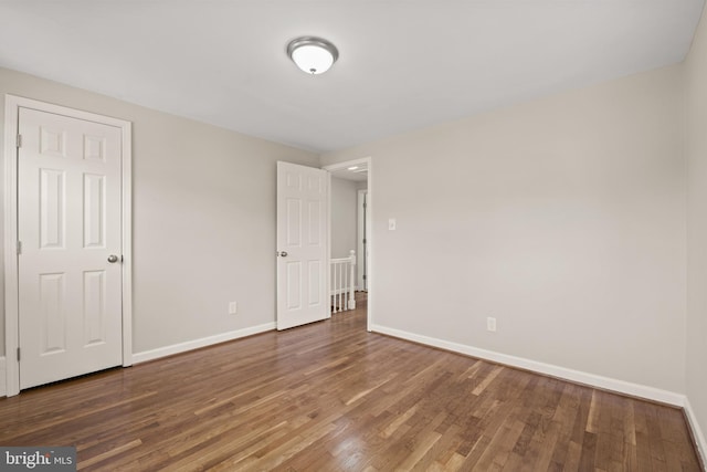 spare room with dark hardwood / wood-style floors