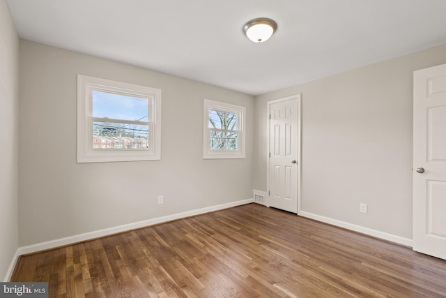 unfurnished room featuring hardwood / wood-style flooring