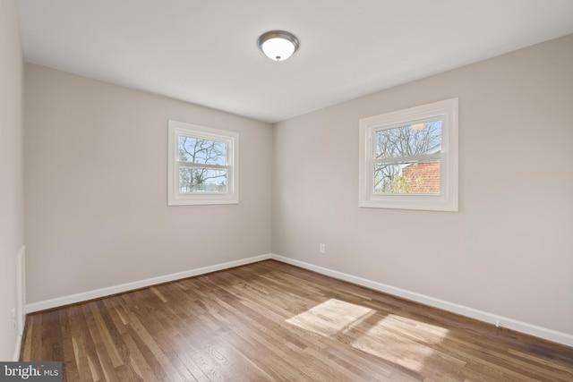 spare room with hardwood / wood-style flooring