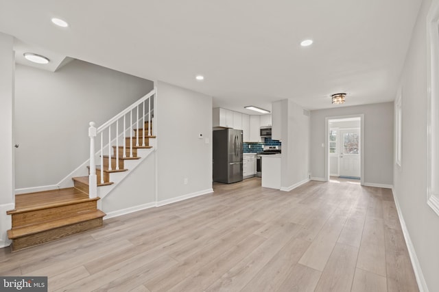 unfurnished living room featuring light hardwood / wood-style floors