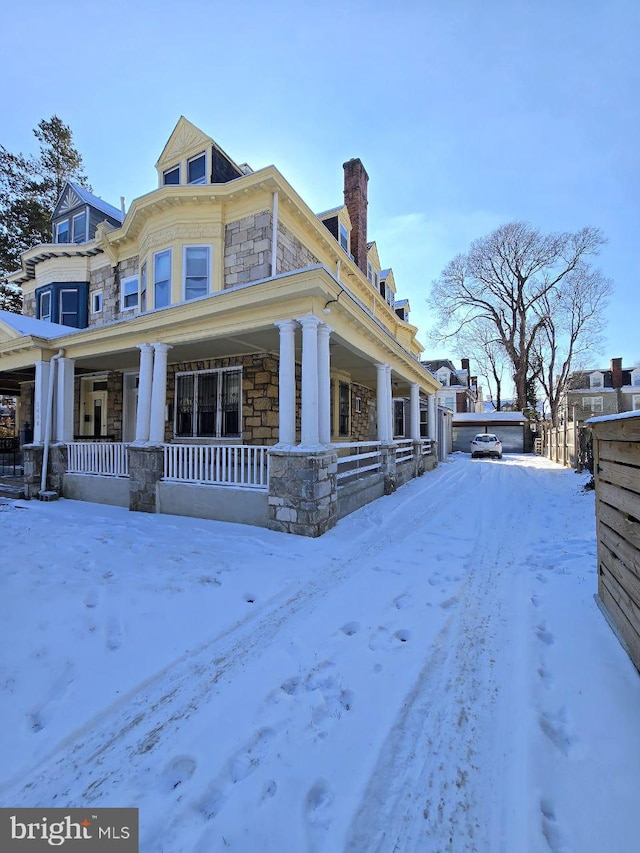 view of snow covered exterior with a porch