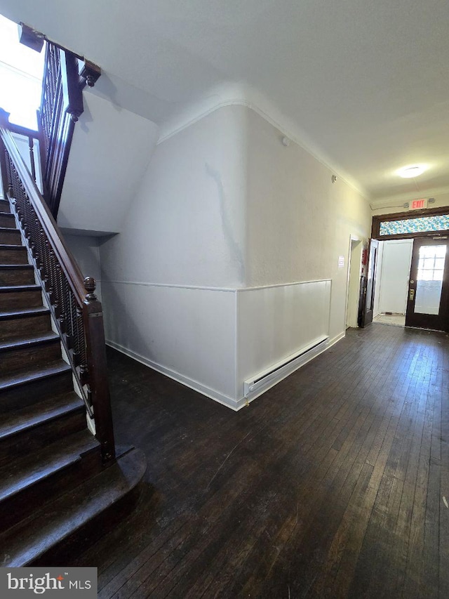 hall featuring baseboard heating, lofted ceiling, and dark wood-type flooring