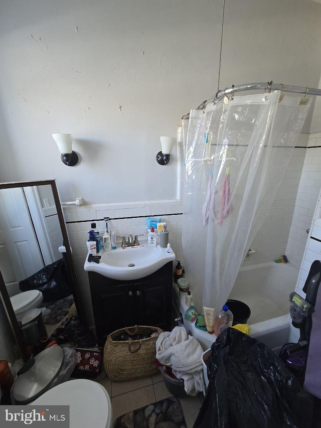 full bathroom featuring shower / tub combo with curtain, toilet, tile walls, vanity, and tile patterned flooring