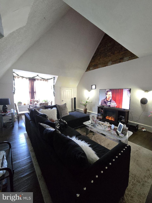 living room with high vaulted ceiling and dark hardwood / wood-style floors