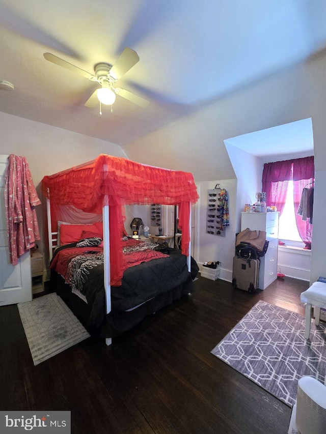 bedroom featuring lofted ceiling, dark wood-type flooring, and ceiling fan