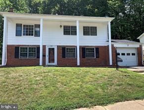 view of front of house with a garage and a front lawn