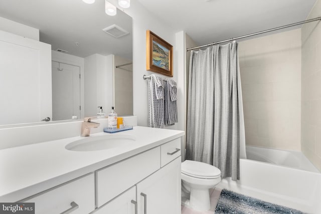 bathroom featuring visible vents, vanity, toilet, and shower / bath combo with shower curtain