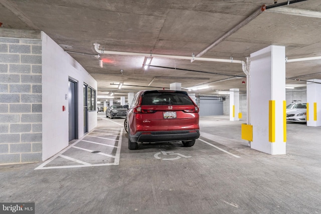 parking garage featuring concrete block wall