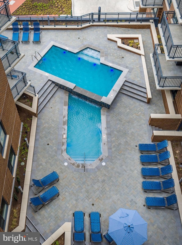 community pool with a patio and a jacuzzi