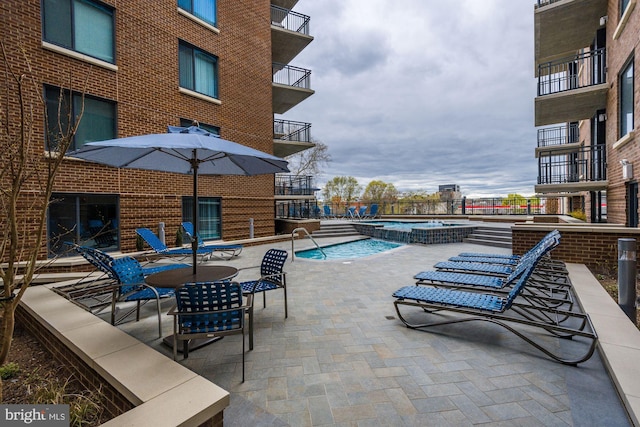 pool featuring a patio area and a hot tub