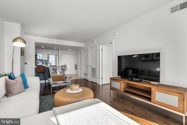 living room with visible vents and wood finished floors