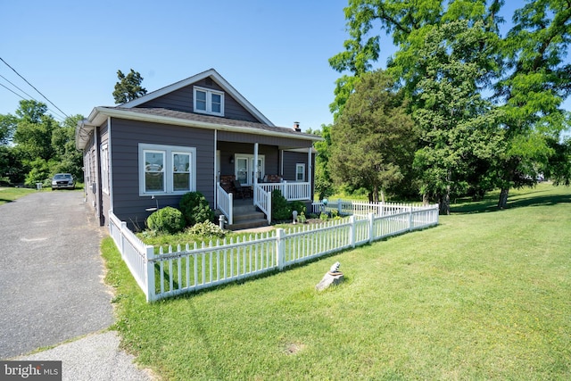 bungalow-style house featuring a porch and a front lawn