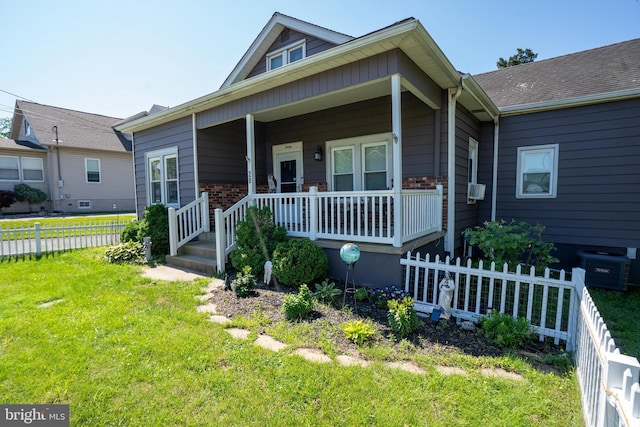 bungalow with covered porch and a front yard