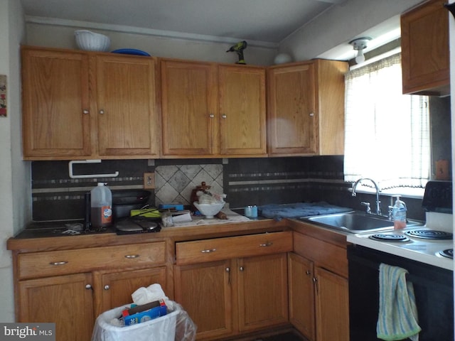 kitchen featuring black range with electric cooktop, backsplash, and sink