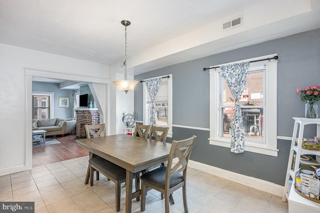 dining space featuring baseboards and visible vents