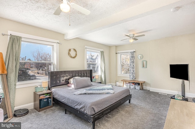 bedroom with a textured ceiling, multiple windows, carpet, and baseboards