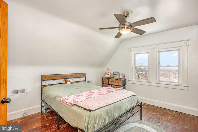 bedroom with ceiling fan, hardwood / wood-style flooring, visible vents, baseboards, and vaulted ceiling