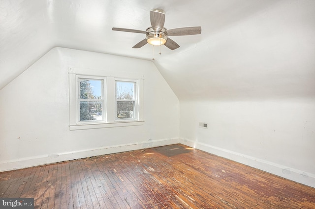bonus room featuring lofted ceiling, wood-type flooring, baseboards, and ceiling fan
