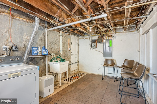 unfinished basement with washer / dryer and electric panel