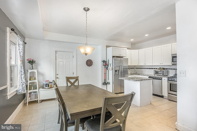 dining space with recessed lighting, baseboards, and light tile patterned floors