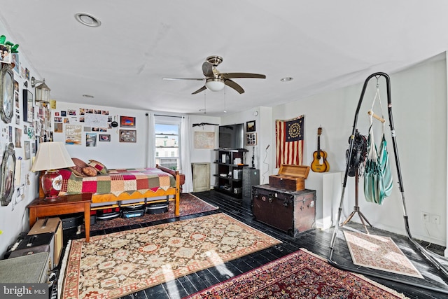 living room featuring ceiling fan and dark hardwood / wood-style flooring