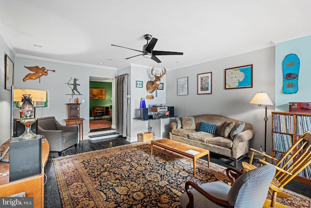 living room featuring ceiling fan, ornamental molding, and hardwood / wood-style floors