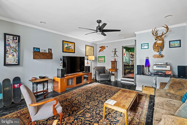 living room with hardwood / wood-style floors, ornamental molding, and ceiling fan