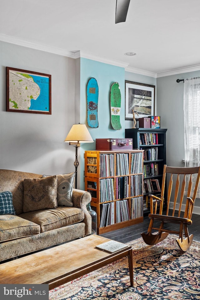 sitting room featuring crown molding and hardwood / wood-style flooring